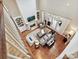 Open-concept living room with a fireplace, built-in shelving, and tall windows for natural light at 11321 James Jack Ln, Charlotte, NC 28277