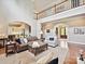 Open living room features a fireplace, tall ceilings, staircase with balcony and plenty of light at 11321 James Jack Ln, Charlotte, NC 28277