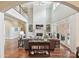 Large living room features tall ceilings, fireplace, built-in shelves and access to the exterior at 11321 James Jack Ln, Charlotte, NC 28277