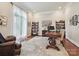Bright office with a large window, built-in bookshelves, and a beautiful wooden desk at 11321 James Jack Ln, Charlotte, NC 28277