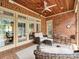 Covered brick patio features brick flooring, wood ceiling, and wicker furniture for stylish outdoor living at 11321 James Jack Ln, Charlotte, NC 28277
