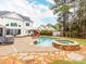 Backyard features a pool, integrated spa, outdoor kitchen, spacious patio, and lounge seating at 123 Yellow Jacket Cir, Mooresville, NC 28117