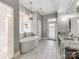 Elegant bathroom featuring a soaking tub, double vanity with granite counters, and tiled floors at 123 Yellow Jacket Cir, Mooresville, NC 28117
