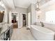 Bathroom showcasing a luxurious soaking tub, marble shower, and access to the bedroom and closet at 123 Yellow Jacket Cir, Mooresville, NC 28117