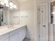 Bright bathroom featuring a long vanity with a white countertop, tiled floors, and ample lighting at 123 Yellow Jacket Cir, Mooresville, NC 28117