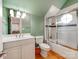 Bathroom features a white vanity, toilet, and tiled shower with a glass door and octagon window at 123 Yellow Jacket Cir, Mooresville, NC 28117