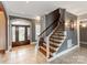 Welcoming foyer with tile flooring, a decorative staircase, and an ornate wooden front door at 123 Yellow Jacket Cir, Mooresville, NC 28117