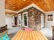 A long covered porch featuring wooden columns and a seating area providing a cozy outdoor space at 123 Yellow Jacket Cir, Mooresville, NC 28117