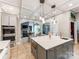 Kitchen island with double ovens, tile floors, pendant lighting, and open to the living room at 123 Yellow Jacket Cir, Mooresville, NC 28117