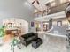 Open-concept living room showcasing high ceilings, wrought iron staircase, and access to the kitchen at 123 Yellow Jacket Cir, Mooresville, NC 28117