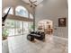 Bright living room with tall windows, tile floors, and an open layout flowing into the kitchen at 123 Yellow Jacket Cir, Mooresville, NC 28117