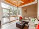 Cozy screened porch with tile flooring and comfortable seating area overlooking the backyard at 123 Yellow Jacket Cir, Mooresville, NC 28117