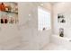 A modern shower with marble-style tiles, glass shelves, and a bench for relaxing at 123 Yellow Jacket Cir, Mooresville, NC 28117
