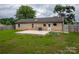 A well-maintained backyard features a concrete patio, brick exterior, and grassy lawn at 133 Pheasant Run Rd, Troutman, NC 28166