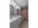 This bathroom features white double sinks and a shower with pink curtain at 133 Pheasant Run Rd, Troutman, NC 28166