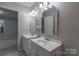 This bathroom features white double sinks and lots of lighting at 133 Pheasant Run Rd, Troutman, NC 28166