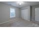 This bedroom features neutral carpeting and paint, and a closet at 133 Pheasant Run Rd, Troutman, NC 28166