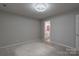 This bedroom features neutral carpeting and paint, with an ensuite bathroom at 133 Pheasant Run Rd, Troutman, NC 28166