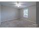 This bedroom features neutral carpeting and paint, and a ceiling fan at 133 Pheasant Run Rd, Troutman, NC 28166