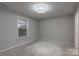 This bedroom features neutral carpeting and paint, and a ceiling fan at 133 Pheasant Run Rd, Troutman, NC 28166