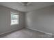 A carpeted bedroom with a bright window allowing natural light in at 133 Pheasant Run Rd, Troutman, NC 28166