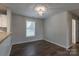 Dining area with dark wood floors, a modern light fixture, and natural light, perfect for Gathering meals at 133 Pheasant Run Rd, Troutman, NC 28166