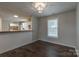 Dining space featuring dark wood floors and access to the kitchen and laundry room, blending functionality and style at 133 Pheasant Run Rd, Troutman, NC 28166