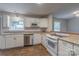 Charming kitchen featuring wood-look floors, a stainless-steel dishwasher, and ample cabinet space with modern appliances at 133 Pheasant Run Rd, Troutman, NC 28166