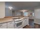 Open concept design kitchen with seamless transition into the living area and an electric cooktop and breakfast bar at 133 Pheasant Run Rd, Troutman, NC 28166