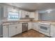Modern kitchen featuring stainless steel appliances, a window over the sink, and a breakfast bar with natural light at 133 Pheasant Run Rd, Troutman, NC 28166