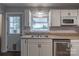 Kitchen showcasing a stainless steel dishwasher, double sink, and outside access, blending functionality with modern amenities at 133 Pheasant Run Rd, Troutman, NC 28166