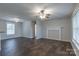 Bright living room with dark wood floors, ceiling fan, and a decorative fireplace mantel enhancing the space at 133 Pheasant Run Rd, Troutman, NC 28166