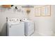 Functional laundry room with a modern washer and dryer set, and overhead shelving at 1338 37Th Avenue Ne Ln, Hickory, NC 28601