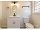 Well-lit bathroom with a vanity, toilet, and modern towel rack at 1401 Woodman Hall St, Shelby, NC 28152