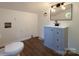 Contemporary bathroom with blue vanity, wood floors, and sleek lighting at 1401 Woodman Hall St, Shelby, NC 28152