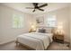 Bedroom featuring neutral walls, plush carpeting, a ceiling fan, and bedside lamps for a cozy ambiance at 1401 Woodman Hall St, Shelby, NC 28152