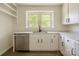 Kitchen features white cabinets, modern stainless steel dishwasher, and an undermount sink at 1401 Woodman Hall St, Shelby, NC 28152
