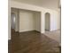 Spacious living area with hardwood flooring and open doorway to the next room at 1401 Woodman Hall St, Shelby, NC 28152