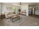 Bright living room with neutral tones, modern furniture, and open kitchen view at 1401 Woodman Hall St, Shelby, NC 28152
