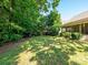 Expansive backyard featuring mature trees and lush green grass, offering ample space for relaxation and outdoor entertainment at 14336 Northridge Dr, Charlotte, NC 28269