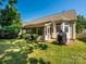 Well-maintained backyard featuring a screened porch, landscaped yard, and lush green grass, ideal for outdoor activities at 14336 Northridge Dr, Charlotte, NC 28269