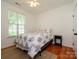 Cozy bedroom with hardwood floors, a bright window, and minimalist decor creating a serene and inviting atmosphere at 14336 Northridge Dr, Charlotte, NC 28269