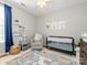 Charming Bedroom with soft colors, a comfortable glider, and playful decor, creating a warm and welcoming space at 14336 Northridge Dr, Charlotte, NC 28269