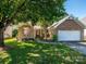 Charming brick home featuring a two-car garage, well-maintained lawn and mature trees at 14336 Northridge Dr, Charlotte, NC 28269