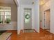 Light-filled foyer featuring hardwood floors, decorative door, and neutral wall paint at 14336 Northridge Dr, Charlotte, NC 28269