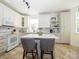 Modern kitchen boasts white cabinets, an island with seating, and stainless steel appliances at 14336 Northridge Dr, Charlotte, NC 28269