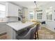 Kitchen features an island with bar seating, white cabinets, and pendant lighting at 14336 Northridge Dr, Charlotte, NC 28269
