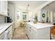Bright kitchen features an island with bar stools and adjacent breakfast nook with many windows at 14336 Northridge Dr, Charlotte, NC 28269