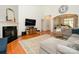 Bright living room featuring a fireplace, hardwood floors, and a large sectional sofa at 14336 Northridge Dr, Charlotte, NC 28269