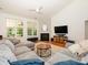 Cozy living room featuring hardwood floors, a fireplace, a ceiling fan, and lots of natural light at 14336 Northridge Dr, Charlotte, NC 28269
